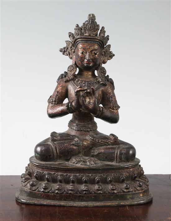 A Sino-Tibetan lacquered bronze seated figure of a Bodhisattva, 16th/17th century, height 23cm